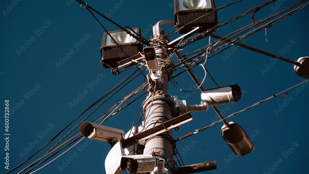 Many CCTV cameras are installed to ensure people's safety. Against the background of a bright sky. Concept of modern technologies, facial recognition, no privacy. Many CCTV cameras are installed to ensure people's safety. Against the background of a bright sky. Concept of modern technologies, facial recognition, no privacy.