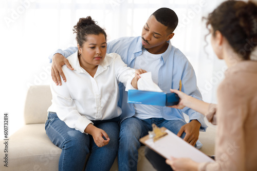 Unhappy black couple attending family therapy session