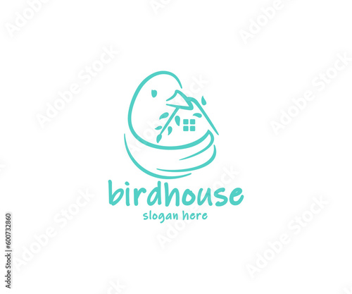 Bird holds in its beak a branch with leaves in the form of a house logo design. The bird flaps its wing, which looks like a nest graphic design