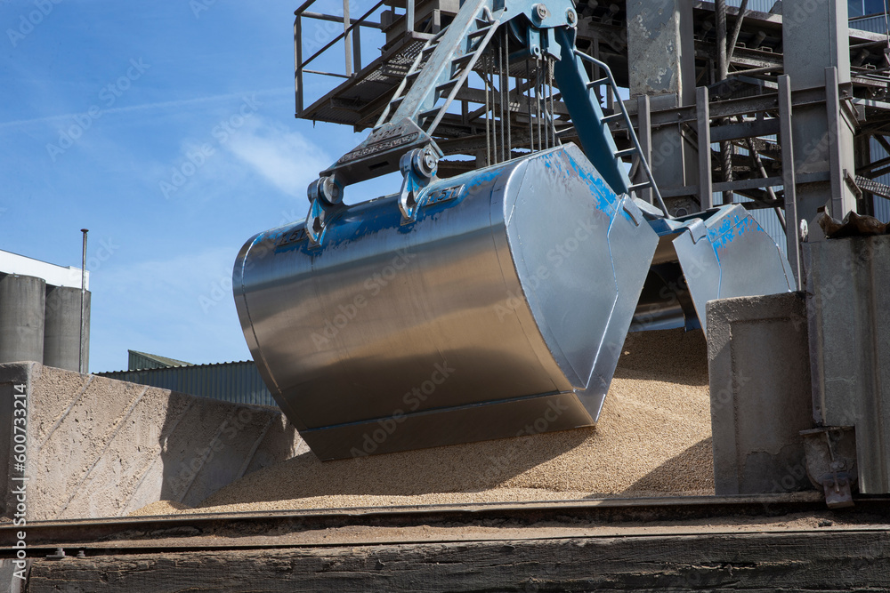 Unloading a ship of soja beans by crane. Barge. Inland vessel. River ...
