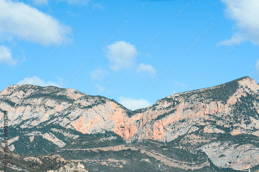 Mountains with blue sky in the background with space for text.
