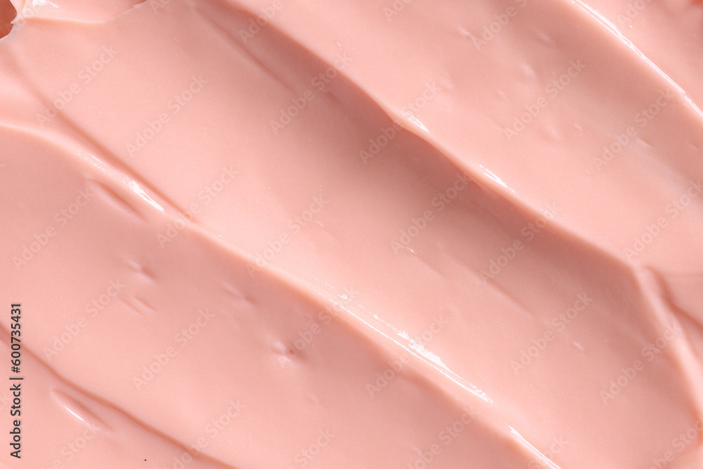 Fototapeta premium Pink skin care cosmetic beauty cream texture background in close up