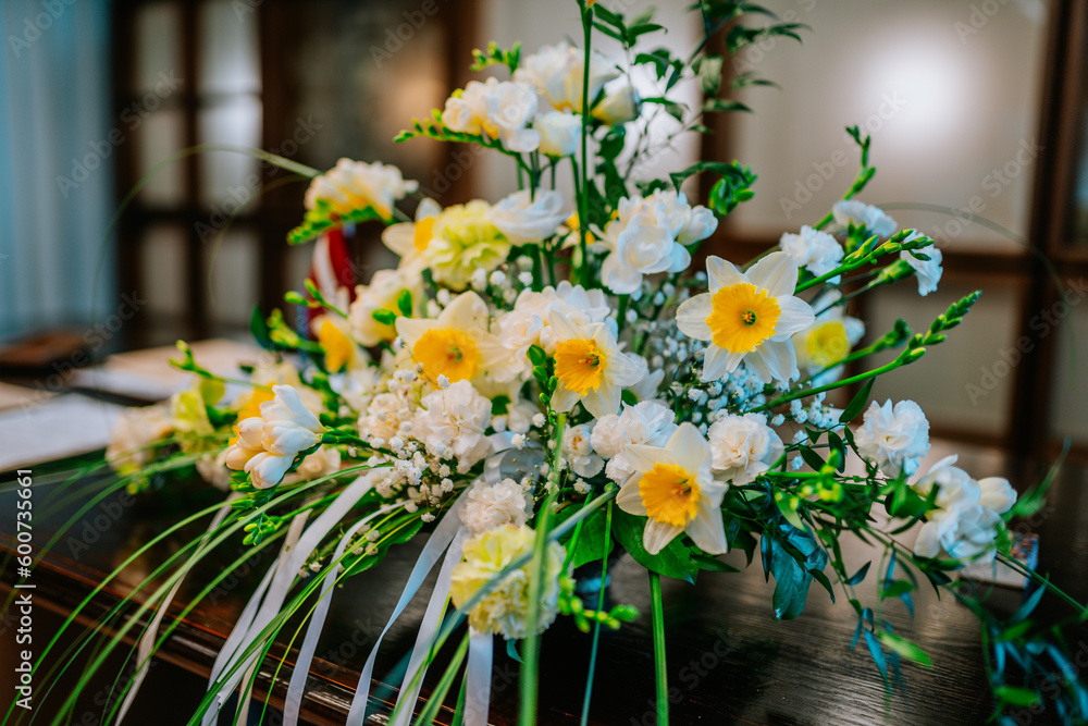 a bouquet of daffodils stands on the table as a decoration