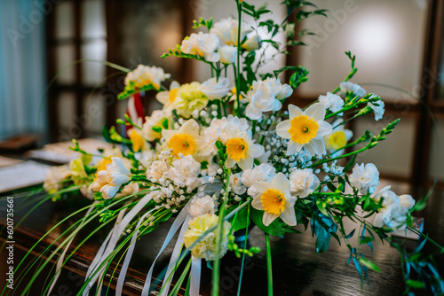 a bouquet of daffodils stands on the table as a decoration