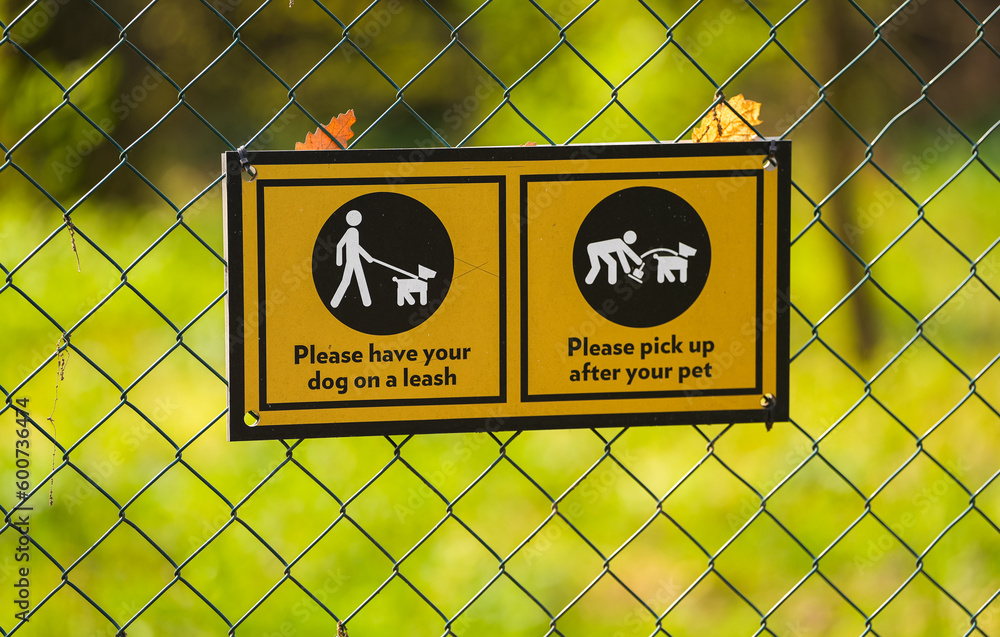 Dog park sign on the fence of a space made for dogs inside a park. Pet friendly park. Dog park sign on the fence of a space made for dogs inside a park. Pet friendly park.