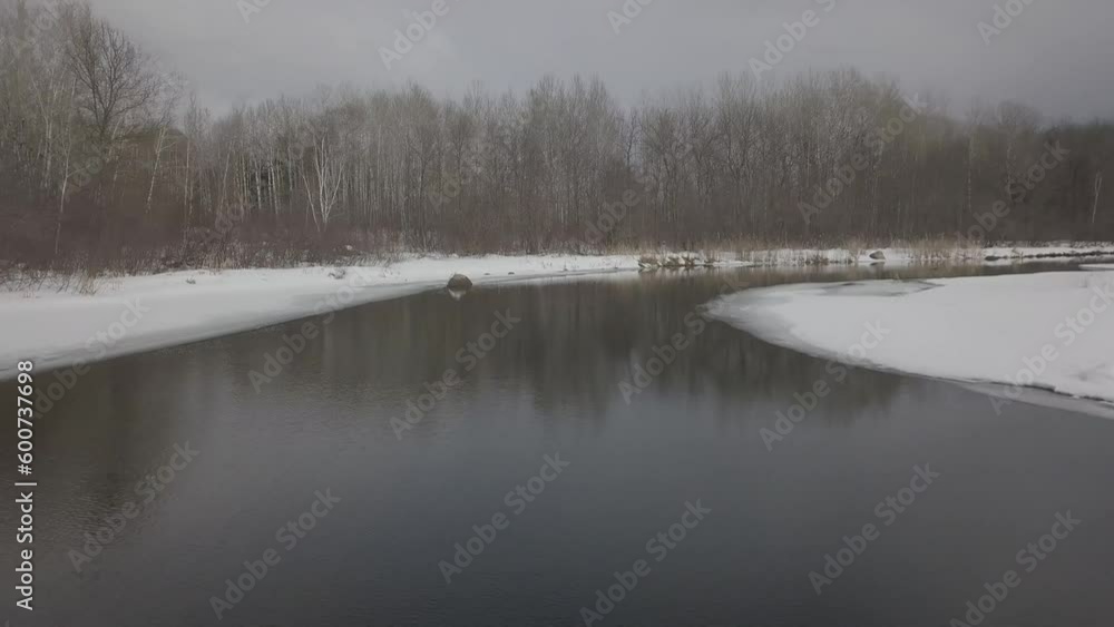 First-person drone flying over river in winter First-person drone flying over river in winter