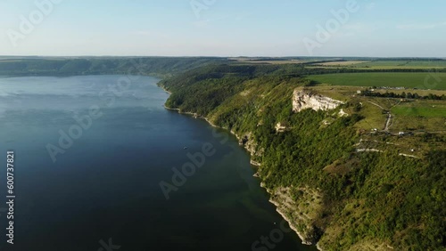 Aerial view flooded village of Bakota and the reservoir of Dniester River in Ukraine. Rocky green hills, part of National park, Podilski Tovtry. Wonderful large lake formed by overflow of river photo