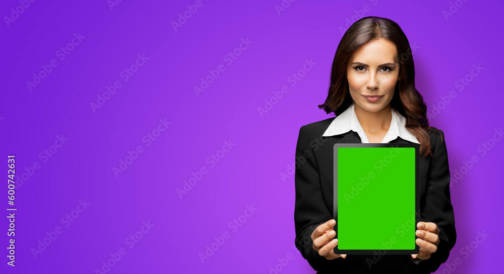 Portrait of serious brunette businesswoman showing tablet pc, touchpad, with green chroma key screen, on violet purple background. Confident attractive business woman at office. Portrait of serious brunette businesswoman showing tablet pc, touchpad, with green chroma key screen, on violet purple background. Confident attractive business woman at office.