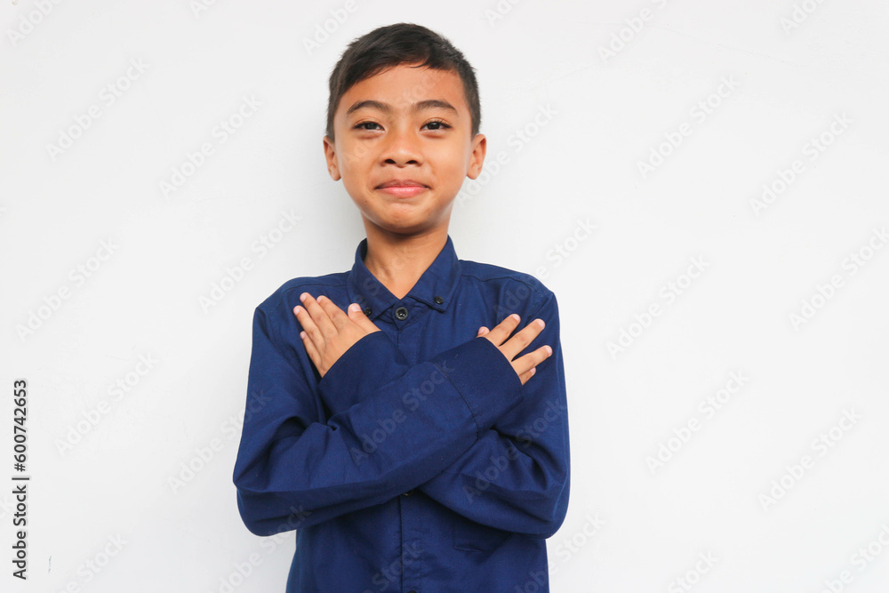 Smiling confidence boy looking at the camera while put his hand on chest, isolated on white background Smiling confidence boy looking at the camera while put his hand on chest, isolated on white background