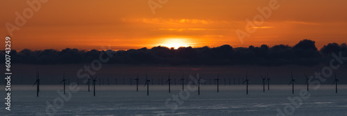 Sunrise over windfarm turbines on north Wales coast