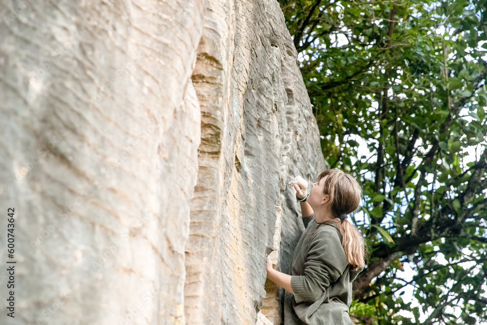 young active teen girl doing outdoor rock climbing bouldering on natural cliff. High quality photo young active teen girl doing outdoor rock climbing bouldering on natural cliff. High quality photo