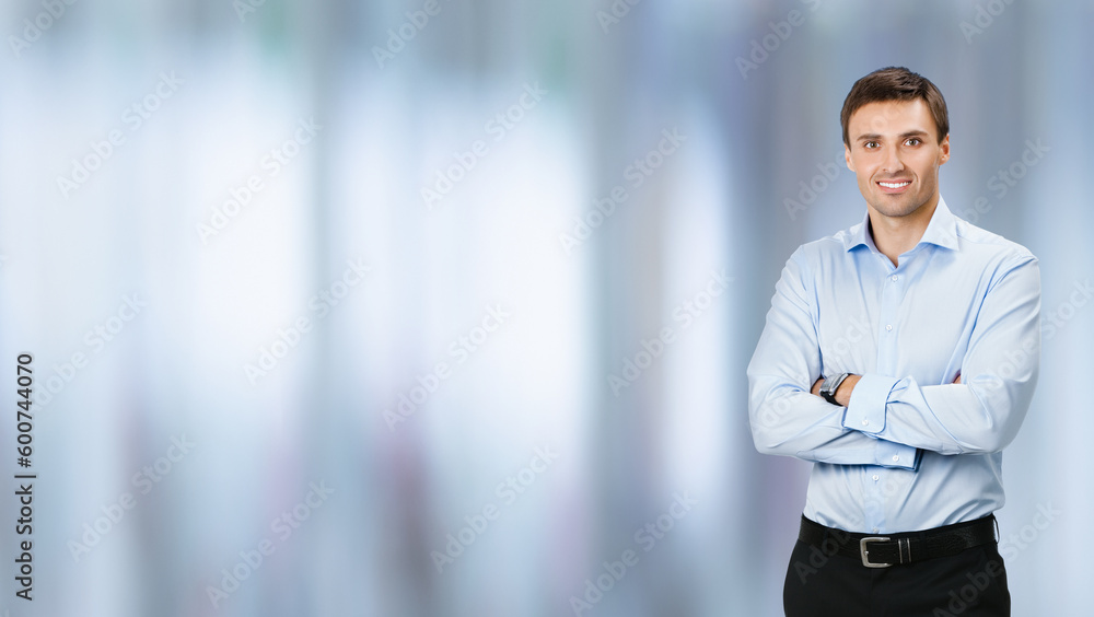 Full body, growth length portrait image - smiling business man in confident cloth, folded hands, on blurred office background. Businessman, bank account manager, real estate sales agent. Full body, growth length portrait image - smiling business man in confident cloth, folded hands, on blurred office background. Businessman, bank account manager, real estate sales agent.