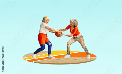 Competition. Two middle-aged, senior women in stylish sportswear playing with basketball ball against light blue background. Concept of sportive lifestyle, health, action and motion. Copy space for ad