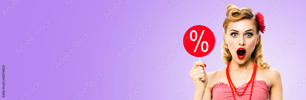 Face portrait of excited shocked woman with open mouth, hold red signboard with % sign. Blond pin up retro style girl. Isolated light purple background. Sale ad concept. Wide image. Face portrait of excited shocked woman with open mouth, hold red signboard with % sign. Blond pin up retro style girl. Isolated light purple background. Sale ad concept. Wide image.