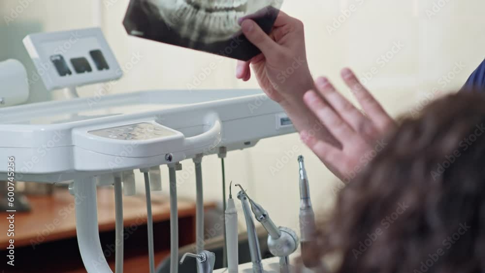 Dentist looking at dental xray plate. Doctor giving consultation to