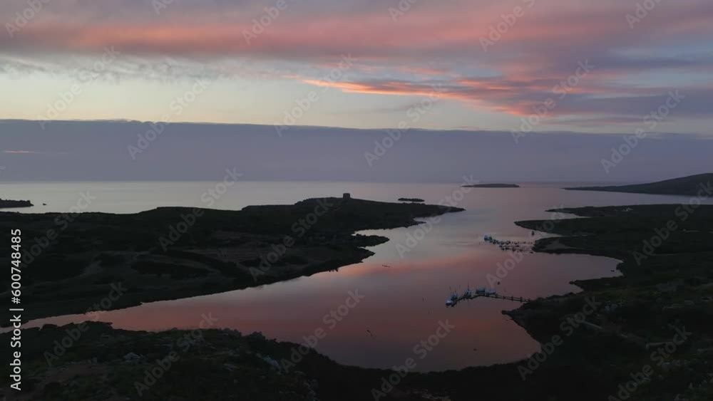 Drone flying back to reveal reflections of sunset in the ocean waters below. Drone flying back to reveal reflections of sunset in the ocean waters below.