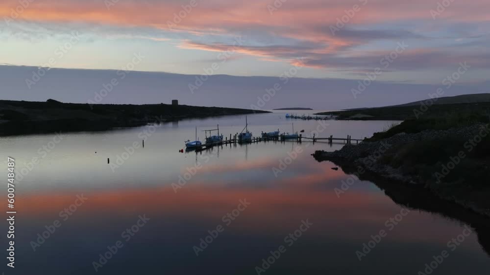 Reflections cast over boats on old wooden jetty in Sa Nitja, Menorca Spain. Reflections cast over boats on old wooden jetty in Sa Nitja, Menorca Spain.