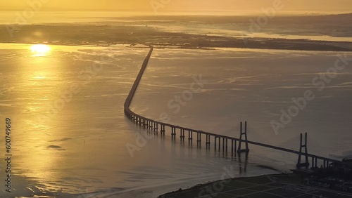 Aerial view on Tajo river mouth with Ponte Vasco da Gama bridge at sunset, Lisbon, Portugal © Ingmar