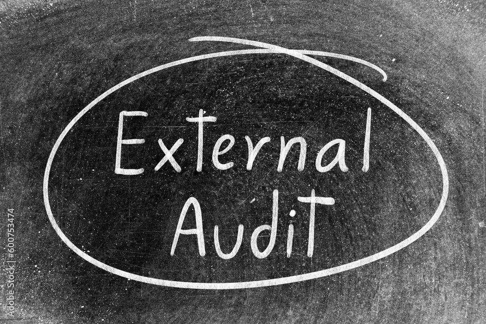 White chalk hand writing in word external audit and circle shape on blackboard background White chalk hand writing in word external audit and circle shape on blackboard background
