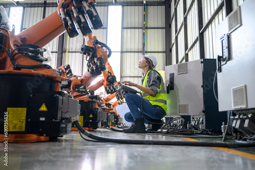 Maintenance engineer worker working with robotic machine automation photo