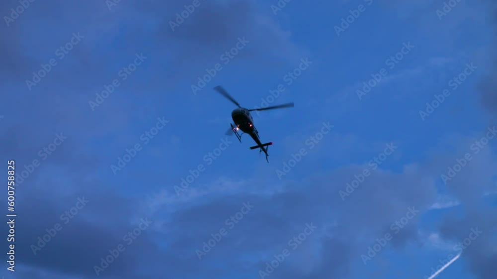 Slow Motion Low Angle View Of Helicopter Flying In Cloudy Sky At Dusk - Los Angeles, California Slow Motion Low Angle View Of Helicopter Flying In Cloudy Sky At Dusk - Los Angeles, California