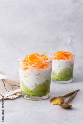 Healthy breakfasts and lunches, avocado and yogurt with chia, grated carrots and radishes in glass cups