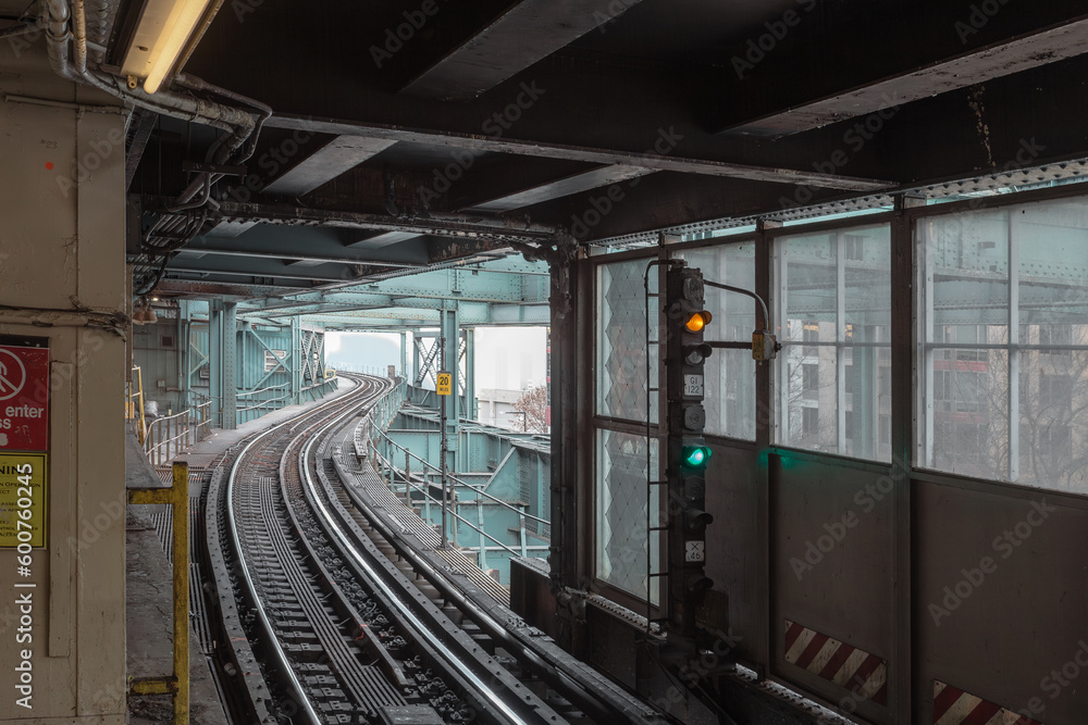 Naklejka premium Curving subway tracks entering station in Queens New York on cold day