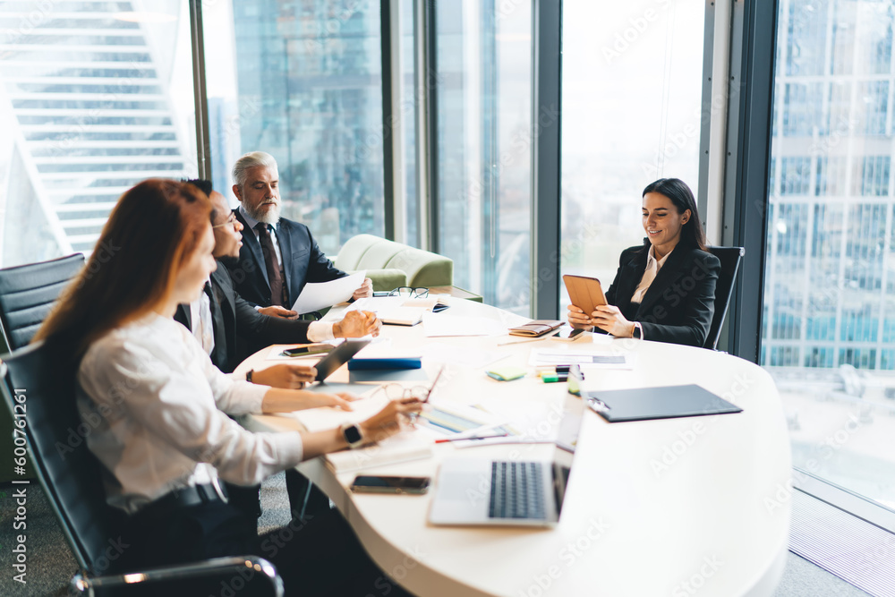 Group of diverse colleagues sitting at table in conference room Group of diverse colleagues sitting at table in conference room