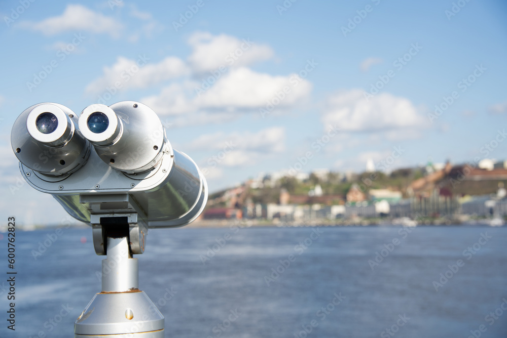 A telescope on the Volga River, looks at the river and the opposite bank, which are in full focus