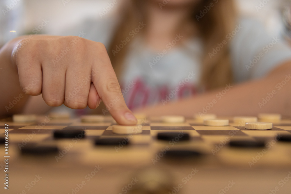 Fototapeta premium close-up view of a hand of elderly woman playing chess.