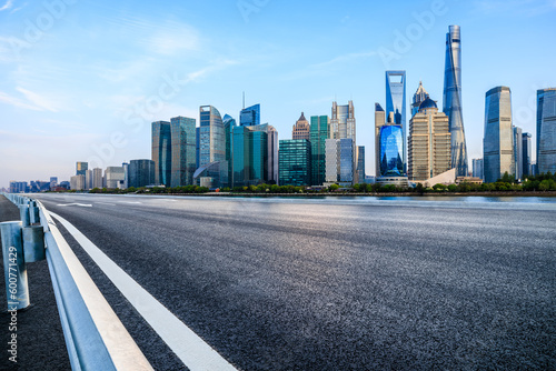 Asphalt road and city skyline with modern buildings in Shanghai, China. © ABCDstock