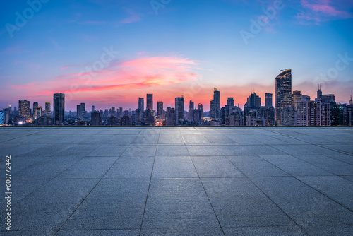 Empty square floor and city skyline with modern buildings at sunset in Shanghai, China. © ABCDstock
