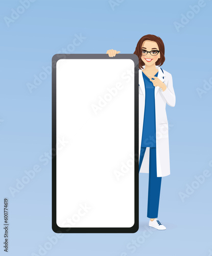 Beautiful doctor or nurse standing behind huge full length and pointing to the blank phone screen vector illustration 
