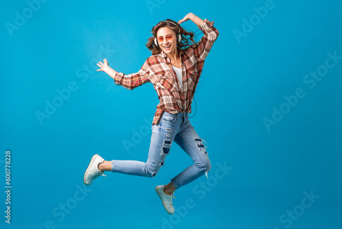 attractive woman in cheerful exited mood listening to music in headphones