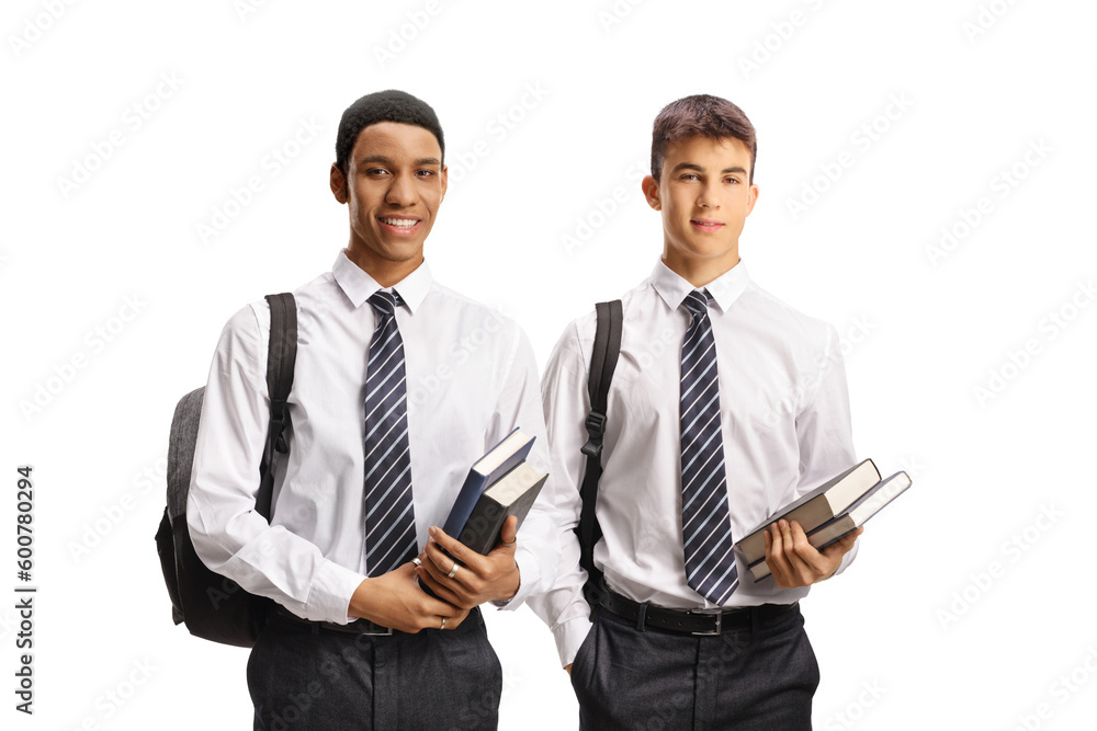 Male students in school uniforms holding books Male students in school uniforms holding books