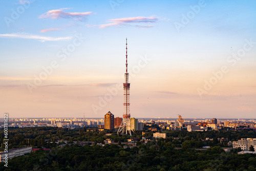 Incredible ruff top view on TV tower in Kyiv during sunset golden hour time with nice gradient sky color in not cloudy evening.