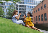 LIttle girls playing outdoor in a city park.