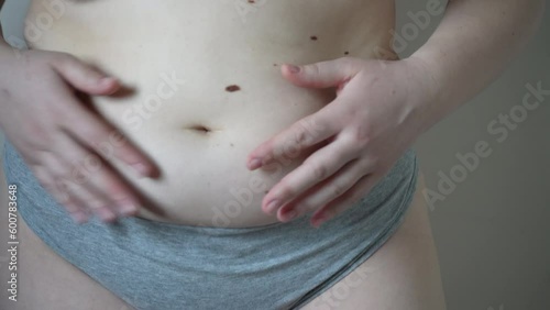 Wallpaper Mural Young overweight woman in sportswear touching belly fat, diet and weight loss. The concept of health care and good body shape. Torontodigital.ca