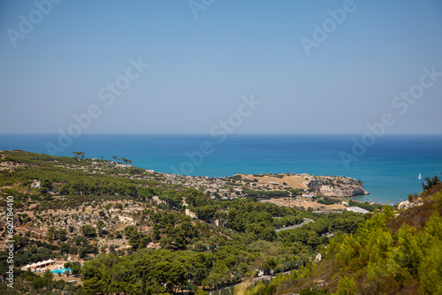 The view from the hill of the sea coast, buildings of Peschici, Puglia, Italy. Vacation on the Adriatic sea