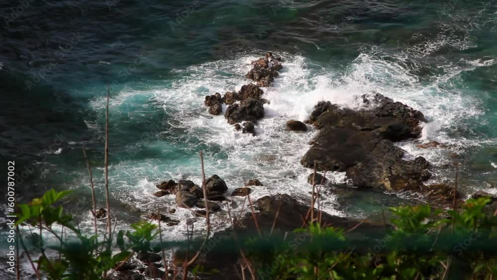 High Angle Lockdown Shot Of Waves Splashing On Rocks In Sea - Kauai, Hawaii High Angle Lockdown Shot Of Waves Splashing On Rocks In Sea - Kauai, Hawaii