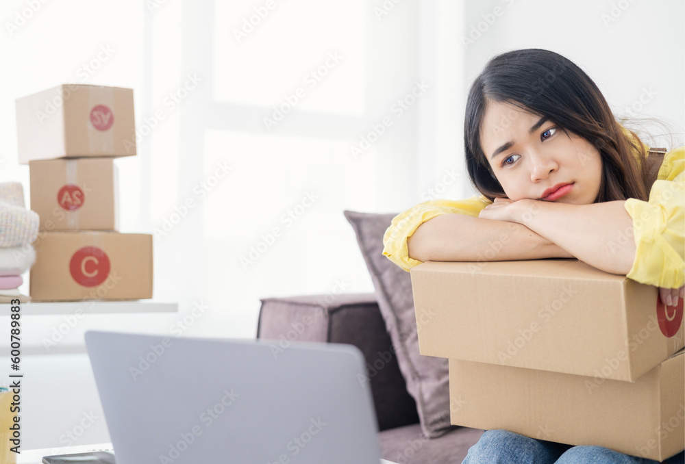 Asian woman think hard serious working laptop computer at home selling online start up small business owner, e-commerce ideas concept.. Asian woman think hard serious working laptop computer at home selling online start up small business owner, e-commerce ideas concept..