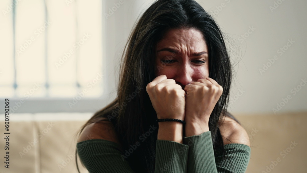 Distressed young woman overwhelmed with anxiety and sadness, feeling helpless and lost at home Distressed young woman overwhelmed with anxiety and sadness, feeling helpless and lost at home