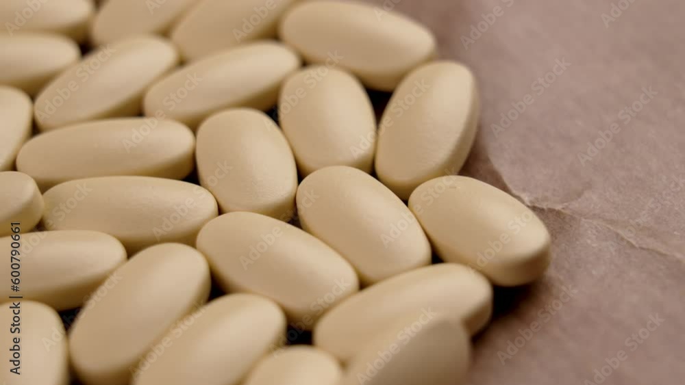 Pharmaceutical medicine in pills on brown paper texture closeup Pharmaceutical medicine in pills on brown paper texture closeup