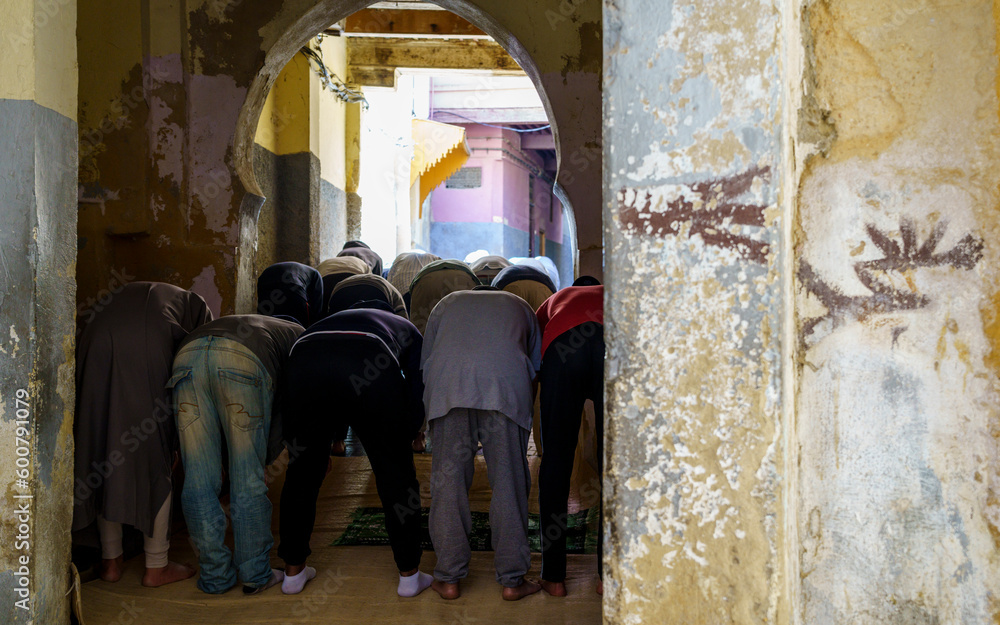 men praying outside a mosque, Fez, morocco, africa