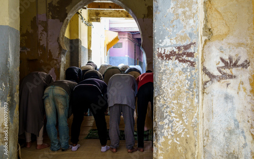 men praying outside a mosque, Fez, morocco, africa