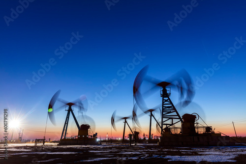 In the evening, oil pumps are running, Silhouette of beam pumping unit