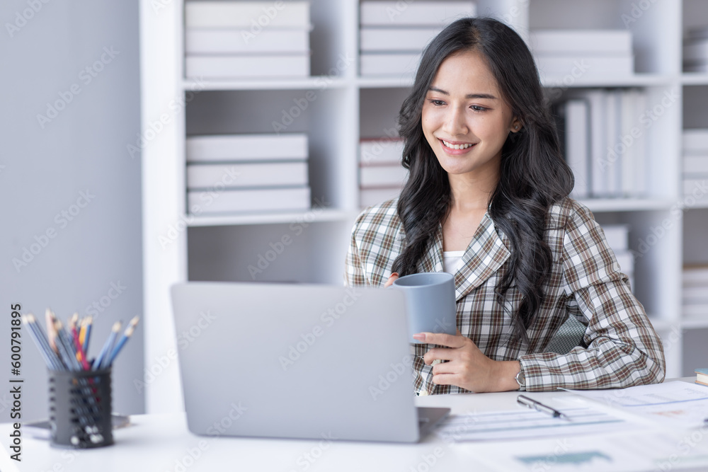 Portrait of Asian business woman holding coffee cup with work in workplace office Business documents money financial planning concept Portrait of Asian business woman holding coffee cup with work in workplace office Business documents money financial planning concept