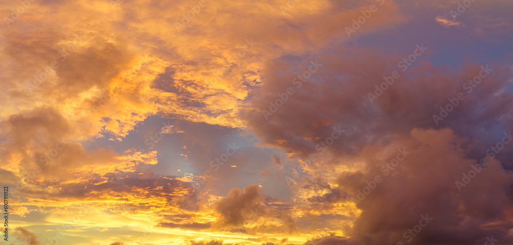 aerial view Bright golden yellow clouds dazzle the sky at sunrise..Bright red-orange sky, beautiful beyond imagination..drone shooting stunning sky full of colorful cloud..abstract nature background. aerial view Bright golden yellow clouds dazzle the sky at sunrise..Bright red-orange sky, beautiful beyond imagination..drone shooting stunning sky full of colorful cloud..abstract nature background.