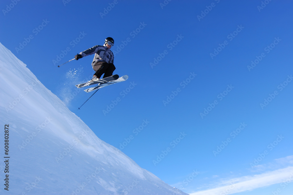 Skier flying off a corncie
