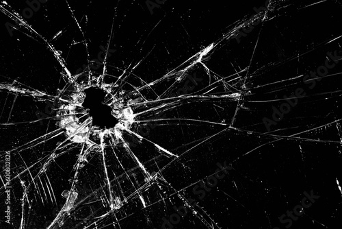 broken glass - cracked with hole over black